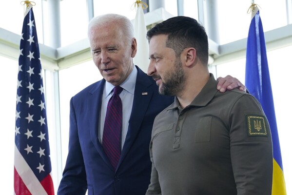 FILE - President Joe Biden, left, walks with Ukrainian President Volodymyr Zelenskyy ahead of a working session on Ukraine during the G7 Summit in Hiroshima, Japan, on May 21, 2023. Russia's war on Ukraine will top the agenda when U.S. President Joe Biden and his NATO counterparts meet in the Lithuanian capital Vilnius on Tuesday and Wednesday. (AP Photo/Susan Walsh, File)