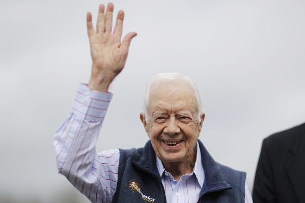 Former President Jimmy Carter waves during a ribbon cutting ceremony for a solar panel project on farmland he owns in their hometown of Plains, Ga., Wednesday, Feb. 8, 2017. Jimmy Carter, who is 92, leased the land to Atlanta-based SolAmerica Energy, which owns, operates, and sells power generated from solar cells. The company estimates the project will provide more than half of the power needed in this town of 755 people. (AP Photo/David Goldman)