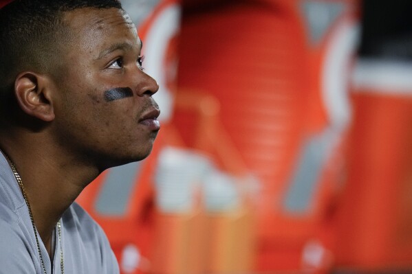 FILE - Boston Red Sox third baseman Rafael Devers looks on from the dugout in the second inning of a baseball game against the Baltimore Orioles, Sept. 29, 2023, in Baltimore. With the Red Sox ramping up at the start of spring training, Devers made it clear Tuesday, Feb. 20, 2024, that he felt the franchise should have done more to improve the roster over the winter. (APPhoto/Julio Cortez, File)