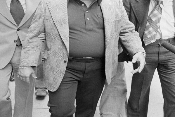 FILe - In this Sept. 4, 1975 file photo, Charles O'Brien,  Jimmy Hoffa's adopted son, leaves the federal court building in Detroit.  O'Brien, a longtime associate of the late Jimmy Hoffa who became a leading suspect in the Teamsters boss' disappearance, has died. O'Brien's stepson, Harvard Law School professor Jack Goldsmith, said in a blog post that O'Brien died Thursday, Feb. 13m 2020 in Boca Raton, Fla., from what appeared to be a heart attack. (AP Photo/Richard Sheinwald, File)