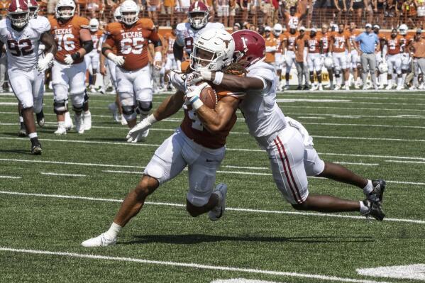 Texas receiver Jordan Whittington, runs after a catch while defended by Alabama defensive back Kool-Aid McKinstry during the first half an NCAA college football game, Saturday, Sept. 10, 2022, in Austin, Texas. (AP Photo/Michael Thomas)