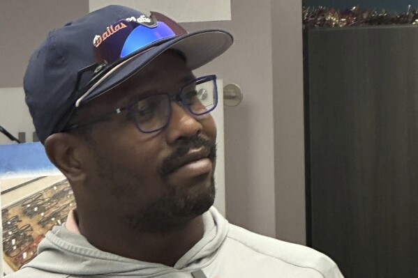 Von Miller playfully tries on a pair of youth frames while attending an event for his charity, Von's Vision, which provides free eye exams and glasses for underprivileged youth, Wednesday, May 28, 2025, in Commerce City, Colo. (AP Photo/Arnie Stapleton)