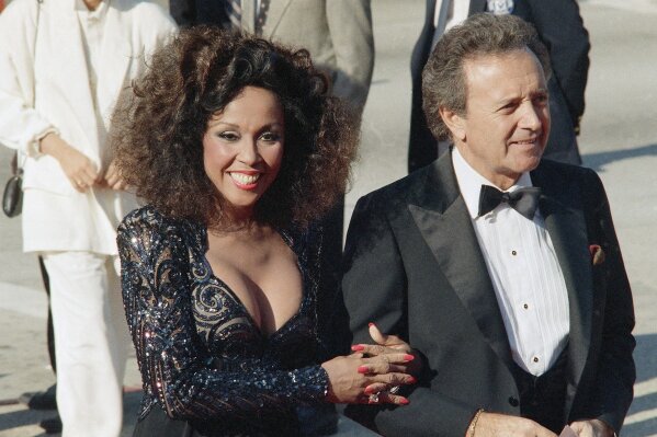 FILE - This Sept. 21, 1986 file photo shows singers Vic Damone, right, and Diahann Carroll at the Emmy awards in Los Angeles. Carroll died, Friday, Oct. 4, 2019, at her home in Los Angeles after a long bout with cancer. She was 84. (AP Photo/Doug Pizac, File)