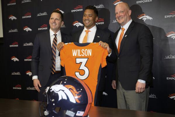 FILE - Denver Broncos new starting quarterback Russell Wilson, center, is flanked by coach Nathaniel Hackett, right, and general manager George Paton after a news conference March 16, 2022, in Englewood, Colo. Hackett said there's never “too high of a price on anybody that’s great" — especially when it comes to quarterbacks. Denver had been dealing with a revolving door of mediocrity at the most important position ever since Peyton Manning retired seven years ago but now has Wilson in place. (AP Photo/David Zalubowski, File)