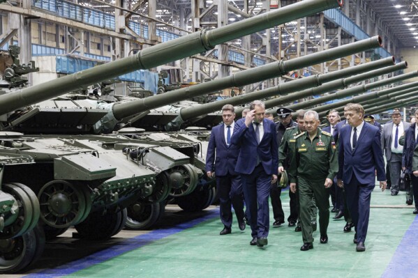 In this photo released by the Russian Defense Ministry Press Service on Friday, April 19, 2024, Russian Defense Minister Sergei Shoigu, second right, visits a factory workshop as he checks the implementation of the state defense order at an enterprise of the military-industrial complex in the Omsk region of Russia, which produces tanks and heavy flamethrower systems. (Russian Defense Ministry Press Service via AP, File)