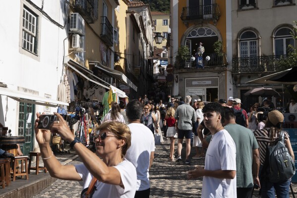 Tourists visit the old center of Sintra, Portugal, Friday, Aug. 9, 2024. (AP Photo/Ana Brigida)