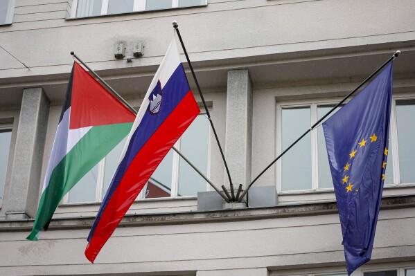 A Palestinian flag flies next to a Slovenian, center, and a European Union flag, right, at the government building in Ljubljana, Slovenia, Thursday, May 30, 2024. Slovenia’s government has endorsed a motion to recognize a Palestinian state and sent it to parliament for approval. Prime Minister Robert Golob's ruling liberal coalition has a comfortable majority in the 90-member assembly and the vote should be formality. The decision by the Slovenian government on Thursday comes just two days after Spain, Norway and Ireland recognized a Palestinian state. It was a move that was slammed by Israel. (AP Photo)