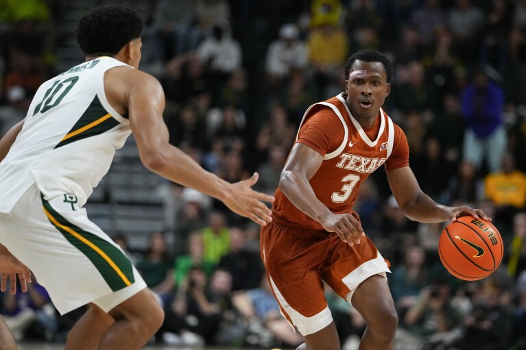 Texas's Max Abmas (3) drives against Baylor's RayJ Dennis (10) during the second half of an NCAA college basketball game, Monday, March 4, 2024, in Waco, Texas. Baylor won 93-85. (AP Photo/Julio Cortez)