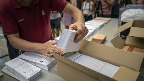 FILE - An election worker shows ballot papers to the media before they are distributed to polling stations, at a warehouse in Barcelona, ​​Spain, July 18, 2023. Claims of electoral fraud and electoral fraud are spreading in Spain ahead of the country's crucial election on Sunday.  The allegations are strikingly similar to claims made by former President Donald Trump and others in the United States ahead of the 2020 election. (AP Photo/Emilio Morenatti, File)