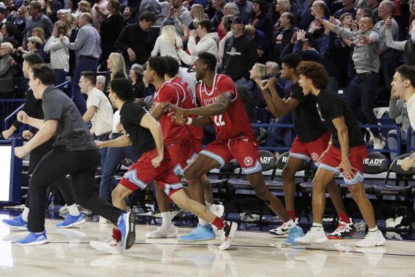 Loyola Marymount celebrates their 68-67 win against Gonzaga at the end of an NCAA college basketball game, Thursday, Jan. 19, 2023, in Spokane, Wash. (AP Photo/Young Kwak)
