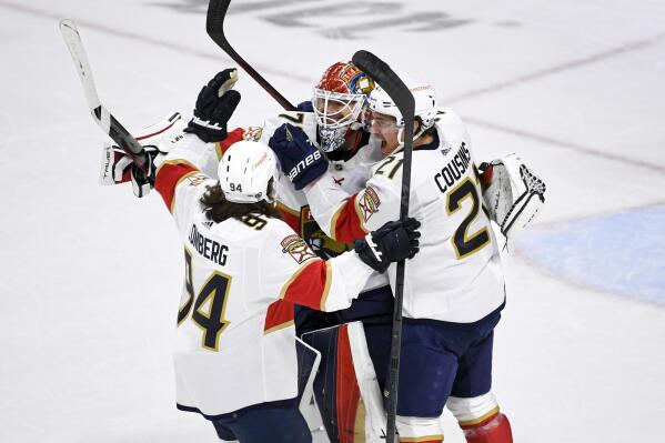 Florida Panthers goalie Sergei Bobrovsky, center, celebrates with center Nick Cousins, right, and left wing Ryan Lomberg after defeating the Minnesota Wild in a shootout of an NHL hockey game Monday, Feb. 13, 2023, in St. Paul, Minn. (AP Photo/Craig Lassig)