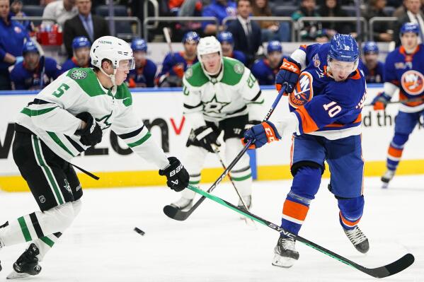 New York Islanders' Simon Holmstrom (10) shoots the puck past Dallas Stars' Nils Lundkvist (5) during the second period of an NHL hockey game Tuesday, Jan. 10, 2023, in Elmont, N.Y. (AP Photo/Frank Franklin II)