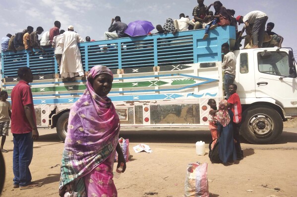 FILE - People board a truck as they leave Khartoum, Sudan, on June 19, 2023. Sudan has been torn by war for a year now, torn by fighting between the military and the notorious paramilitary Rapid Support Forces. (AP Photo, File)