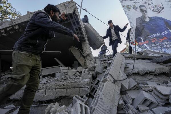 Palestinians inspect the ruins of the house of Palestinian militant, Mohammad Souf, that was demolished by Israeli troops in the West Bank village of Haris, Wednesday, May 3, 2023. Israeli forces demolish the house of a Palestinian man who killed three Israelis in an attack in the occupied West Bank settlement of Ariel in November 2022. Mohammad Souf, 18, stabbed two people, then stole a car and rammed it into a third person before he was shot dead by Israeli security forces. (AP Photo/Majdi Mohammed)