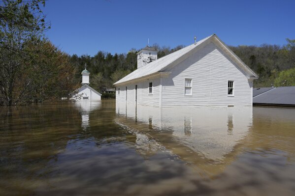 Two churches, one Catholic and one Baptist are flooded by the Kentucky River in Lockport, Ky., Tuesday, April 8, 2025. (AP Photo/Carolyn Kaster, File)