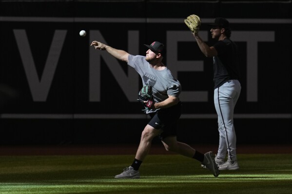 Arizona Diamondbacks starting pitchers Merrill Kelly, left, and Brandon Pfaadt work out Friday, Oct. 13, 2023, at Chase Field in Phoenix as the team prepares to play against the Philadelphia Phillies in the baseball NL Championship Series. (AP Photo/Ross D. Franklin)