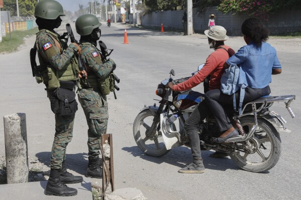 Soldiers patrol the road near the international airport in Port-au-Prince, Haiti, Wednesday, March 13, 2024. (AP Photo/Odelyn Joseph)