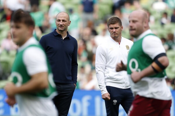 FILE - England's head coach Steve Borthwick, left, with Owen Farrell before a start for the international rugby union match between Ireland and England, at Aviva Stadium, Dublin, Ireland, on Aug. 19, 2023. Rarely has England gone into a Rugby World Cup with so little external expectation. The English have long been Europe’s big hope on the global stage and the team that most concerned the big guns from the southern hemisphere. (AP Photo/Peter Morrison, File)