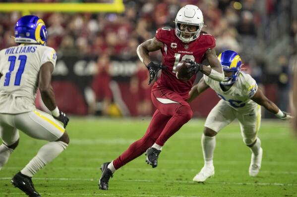 FILE - Wide receiver DeAndre Hopkins (10) of the Arizona Cardinals catches a pass and runs against the Los Angeles Rams in an NFL football game on Dec. 13, 2021, in Glendale, Ariz. Hopkins returns for the Cardinals' game against the New Orleans Saints on Thursday, Oct. 20, 2022. The three-time All-Pro is back after a six-game suspension for violating the NFL's policy on performance-enhancing drugs. (AP Photo/Jeff Lewis, File)
