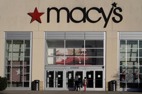 FILE - In this Feb. 22, 2021 file photo, shoppers arrive at a Macy's in Charlotte, N.C. Macy’s emerged from an unprecedented year by swinging to a profit and it upped its expectations for the year. The retailer on Tuesday, May 18, 2021, posted net income of $103 million, after reporting a loss in the same period a year earlier. (AP Photo/Chris Carlson, File)