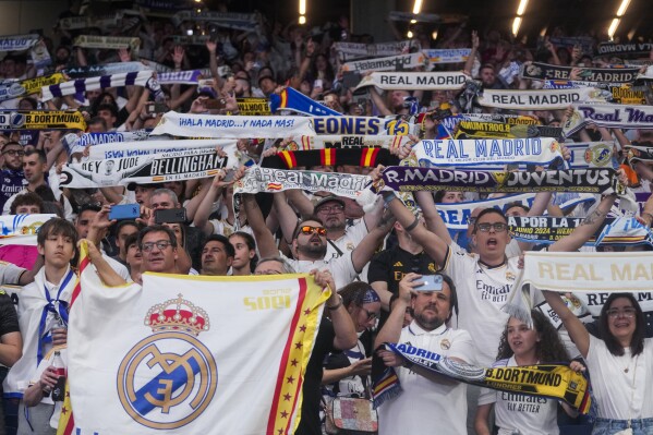 Real Madrid fans gather at Santiago Bernabeu stadium to watch on screens the Champions League final soccer match between Real Madrid and Borussia Dortmund, in Madrid, Spain, Saturday, June 1, 2024. (AP Photo/Paul White)
