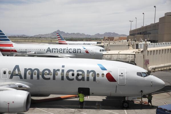 This June 7, 2021, photo shows an American Airlines aircraft at Phoenix Sky Harbor International Airport in Phoenix. American Airlines said Tuesday it expects to report roughly break-even results for the second quarter thanks to $1.4 billion in special items, mostly federal pandemic aid that covered most of the airline's payroll costs. (AP Photo/Jenny Kane, file)