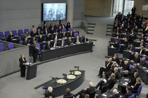 Holocaust survivor Eva Szepesi speaks to the plenary of the German Bundestag in Berlin, Germany, Wednesday, Jan. 31, 2024. The German parliament remembers the victims of National Socialism at a Ceremony of Remembrance at the Reichstag in Berlin. (AP Photo/Ebrahim Noroozi)
