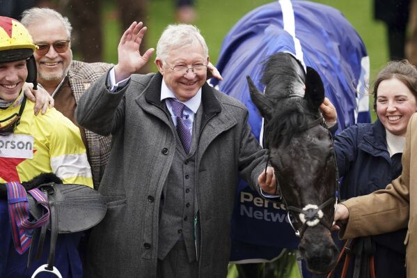 Former Manchester United manager Alex Ferguson, owner of Monmiral, celebrates winning the Pertemps Network Final, which was ridden to victory by Harry Cobden on day three of the 2024 Cheltenham Festival at Cheltenham Racecourse, England, Thursday March 14, 2024. Former Manchester United manager Alex Ferguson claimed two winners in the space of 40 minutes for his first triumphs at the prestigious horse racing meeting. (Mike Egerton/PA via AP)