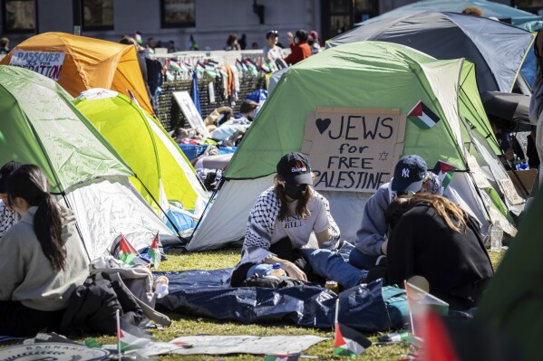 Student protesters sit in front of a tent during the Pro-Palestinian protest at the Columbia University campus in New York, Monday April 22, 2024. (AP Photo/Stefan Jeremiah)