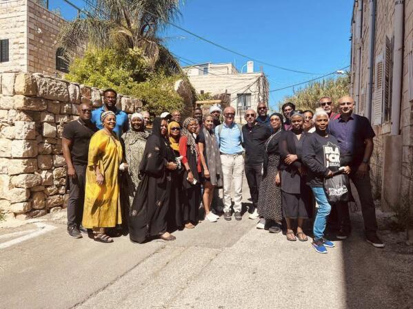 In this photo provided by Black Jerusalem, members of the “Black Jerusalem” trip pose for a photograph in the Ein Karem neighborhood of Jerusalem, on Friday, Sept. 29, 2023. The group, comprising of leaders across Abrahamic faiths, traveled to explore “the sacred geography of Jerusalem” through a Black American and African lens. (Black Jerusalem via AP)