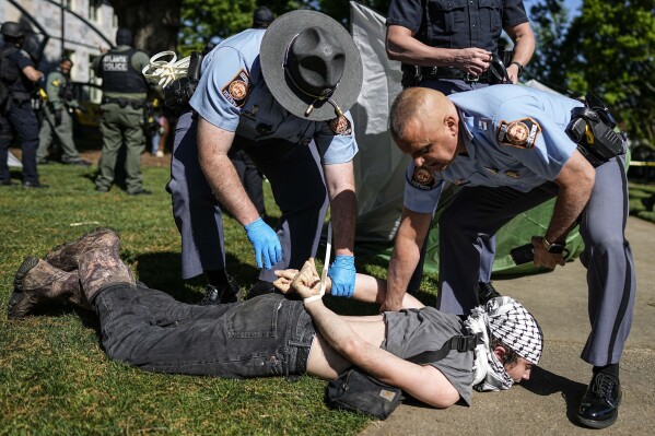 Georgia State Patrol officers arrest a protester on the Emory University campus during a pro-Palestinian demonstration Thursday, April 25, 2024, in Atlanta.  (AP Photo/Mike Stewart)