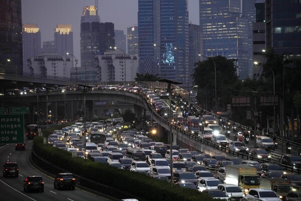 Cars and motorbikes are caught in rush hour traffic at the main business district in Jakarta, Indonesia, Tuesday, Aug. 15, 2023. A plan for how Indonesia will spend $20 billion to transition to cleaner energy was submitted Wednesday, Aug. 16, to the government and its financing partners, the planners said. (AP Photo/Dita Alangkara)