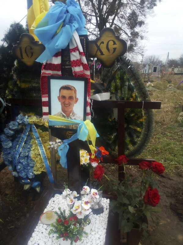 This photo provided by the family shows the grave of Oleksandr “Sasha” Romanovych Hrysiuk, who was buried in Kvitneve, Ukraine, in March 2023. Olha visits her son’s grave every day, to sit with him, talk with him and pray that he – and perhaps she herself -- finds peace. (Courtesy Olha Hrysiuk via AP)