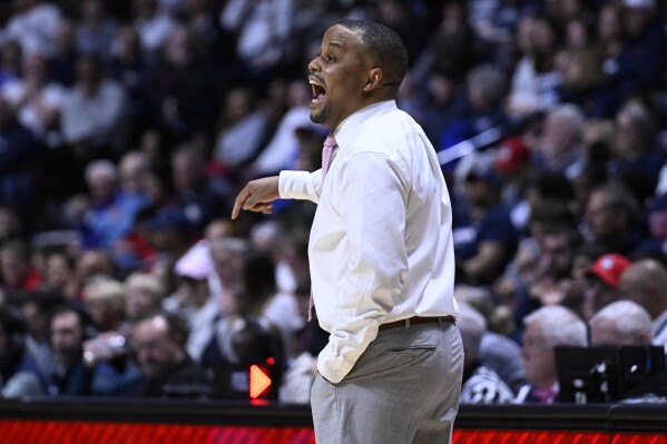 FILE - Georgetown interim coach Darnell Haney gestures during the first half of the team's NCAA college basketball game against UConn in the finals of the Big East women's tournament March 11, 2024, in Uncasville, Conn. Haney was promoted to coach of the team Wednesday, March 20, after one season in an interim role succeeding the late Tasha Butts. (AP Photo/Jessica Hill, File)