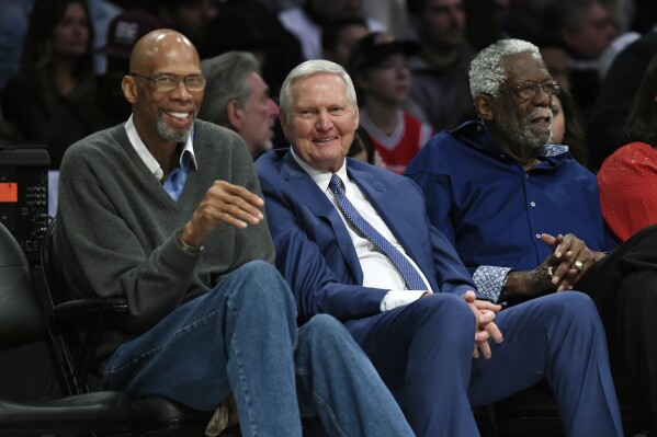 FILE - Former basketball players, from left, Kareem Abdul-Jabbar, Jerry West and Bill Russell watch during the first half of an NBA All-Star basketball game, Sunday, Feb. 18, 2018, in Los Angeles. Jerry West, who was selected to the Basketball Hall of Fame three times in a storied career as a player and executive and whose silhouette is considered to be the basis of the NBA logo, died Wednesday morning, June 12, 2024, the Los Angeles Clippers announced. He was 86.(AP Photo/Chris Pizzello, File)