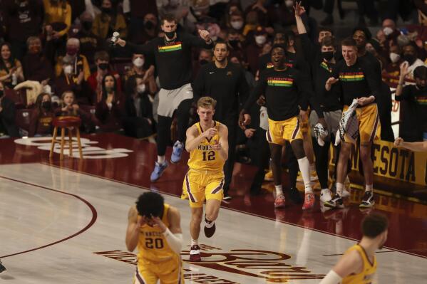Minnesota guard Luke Loewe (12) reacts after making a 3-point basket during the second half of an NCAA college basketball game against Northwestern, Saturday, Feb. 19, 2022, in Minneapolis. (AP Photo/Stacy Bengs)