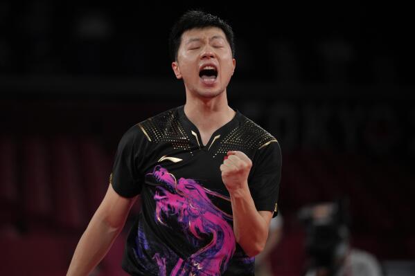 Ma Long of China reacts after defeating Fan Zhendong of China during the gold medal match of the table tennis men's singles at the 2020 Summer Olympics, Friday, July 30, 2021, in Tokyo. (AP Photo/Kin Cheung)