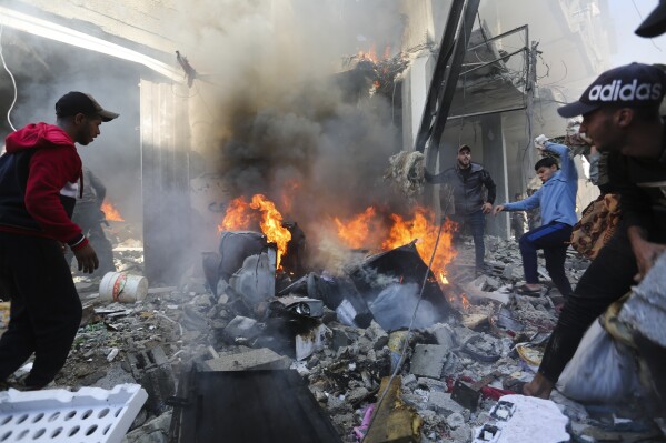 Palestinians look for survivors after an Israeli strike on Rafah, Gaza Strip, Friday, Nov. 17, 2023. (AP Photo/Hatem Ali)