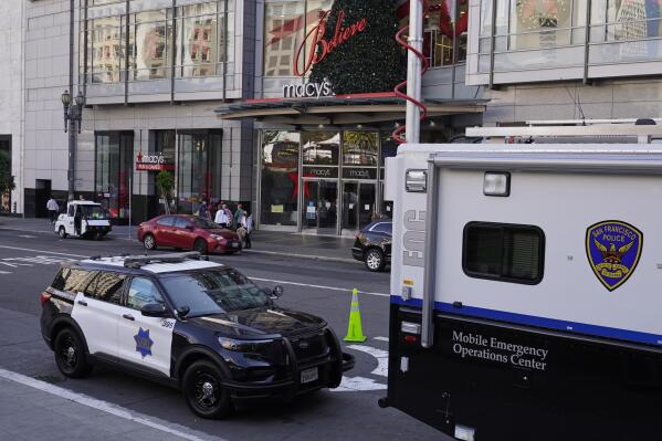 Police vehicles are stationed at Union Square following recent robberies in San Francisco, Thursday, Dec. 2, 2021. In San Francisco, homeless tents, open drug use, home break-ins and dirty streets have proliferated during the pandemic. The quality of life crimes and a laissez-faire approach by officials to brazen drug dealing have given residents a sense the city is in decline.(AP Photo/Eric Risberg)