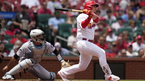 St. Louis Cardinals' Nolan Gorman, right, follows through on a three-run home run as Miami Marlins catcher Jacob Stallings, left, watches during the first inning of a baseball game Wednesday, July 19, 2023, in St. Louis. (AP Photo/Jeff Roberson)