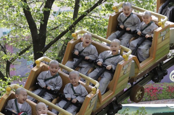 
              In this May 2, 2019, photo, Shaven-headed children ride a roller coaster during their visit at the Everland amusement park in Yongin, South Korea. Ten children entered a temple to have an experience of monks' life for three weeks. Buddhists visit a temple across the country to celebrate the Buddha's upcoming birthday on May 12. (AP Photo/Lee Jin-man)
            