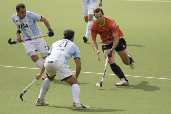 Australia's Tom Craig, right, is defended by Argentina's Tomas Domene, center, during the FIH Hockey Pro League mini tournament game between Australia and Argentina at the Wilrijkse Plein in Antwerp, Belgium, Thursday, May 30, 2024. (AP Photo/Virginia Mayo, File)