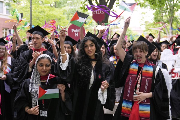 Graduates wave Palestinian flags during commencement ceremonies at Harvard University, Thursday, May 29, 2025, in Cambridge, Mass. (AP Photo/Charles Krupa)