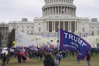 FILE - Rioters walk on the West Front of the U.S. Capitol on Jan. 6, 2021, in Washington. Two Montana brothers whom authorities say were among the first to break into the U.S. Capitol while Congress was certifying the 2020 election have pleaded guilty to obstruction of an official proceeding. Jerod and Joshua Hughes face a maximum of 20 years in prison. (AP Photo/John Minchillo, File)