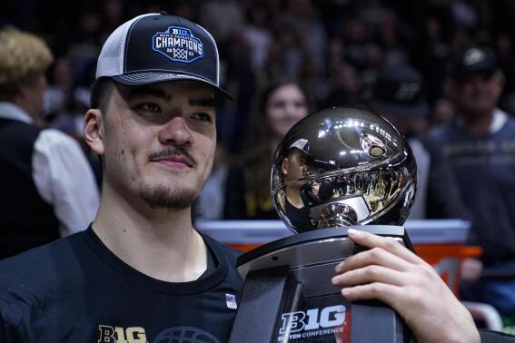 Purdue center Zach Edey (15) holds the Big Ten Championship trophy following an NCAA college basketball game against Illinois in West Lafayette, Ind., Sunday, March 5, 2023. Purdue defeated Illinois 76-71. (AP Photo/Michael Conroy)