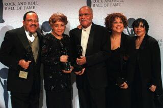 FILE - In tis March 15, 1999 file photo, The Staple Singers, from left, Pervis, Cleotha, Pops, Mavis, and Yvonne pose at the Rock and Roll Hall of Fame induction ceremony in New York. Pervis Staples, whose tenor voice complimented his father’s and sisters’ in The Staple Singers, died Thursday, May 6, 2021, at his home in Dalton, Ill., a spokesman for sister Mavis Staples, said Wednesday, May 12 , 2021. He was 85.  (AP Photo/Albert Ferreira, File)
