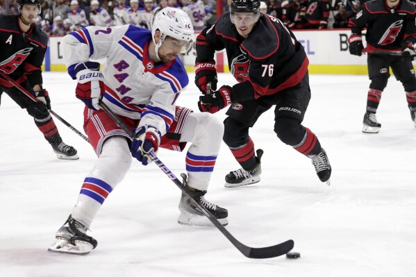 New York Rangers center Filip Chytil (72) drives against Carolina Hurricanes defenseman Brady Skjei (76) during the third period in Game 3 of an NHL hockey Stanley Cup second-round playoff series Thursday, May 9, 2024, in Raleigh, N.C. (AP Photo/Chris Seward)