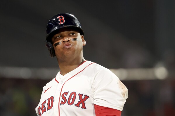Boston Red Sox designated hitter Rafael Devers reacts after striking out during the eighth inning of a baseball game against the Texas Rangers, Tuesday, May 6, 2025, in Boston. (AP Photo/Mark Stockwell)