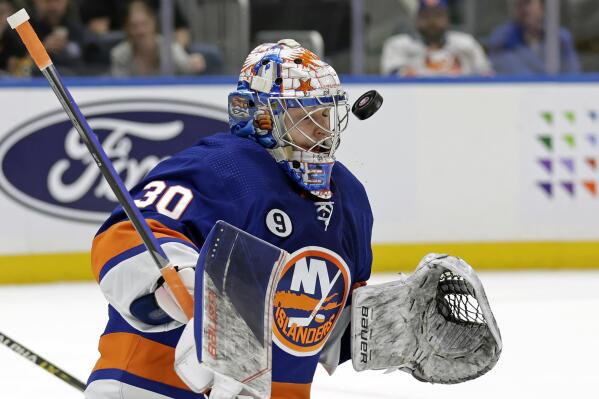 New York Islanders goaltender Ilya Sorokin makes a save in the first period of an NHL hockey game against the Pittsburgh Penguins, Tuesday, April 12, 2022, in Elmont, N.Y. (AP Photo/Adam Hunger)