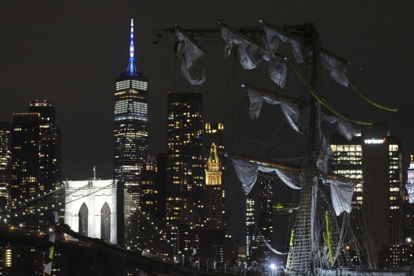 The New York skyline and Brooklyn Bridge are framed in one of the snapped masts of a Mexican Navy training ship after it collided with the Brooklyn Bridge, Saturday, May 17, 2025, in New York. (AP Photo/Yuki Iwamura)